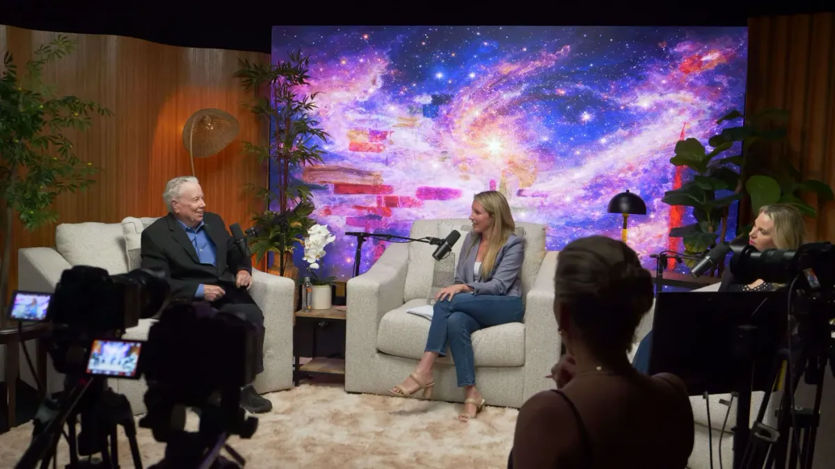 Three-person interview at The Lounge with galaxy nebula LED wall and full camera crew Las Vegas