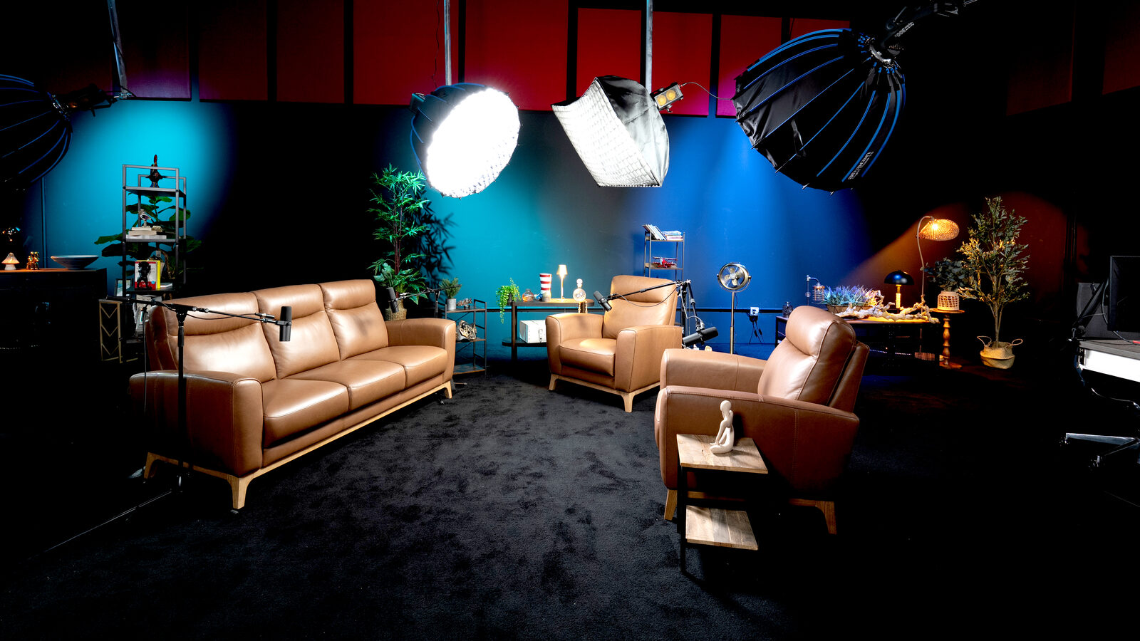 Lounge studio leather couch and chairs with blue lighting