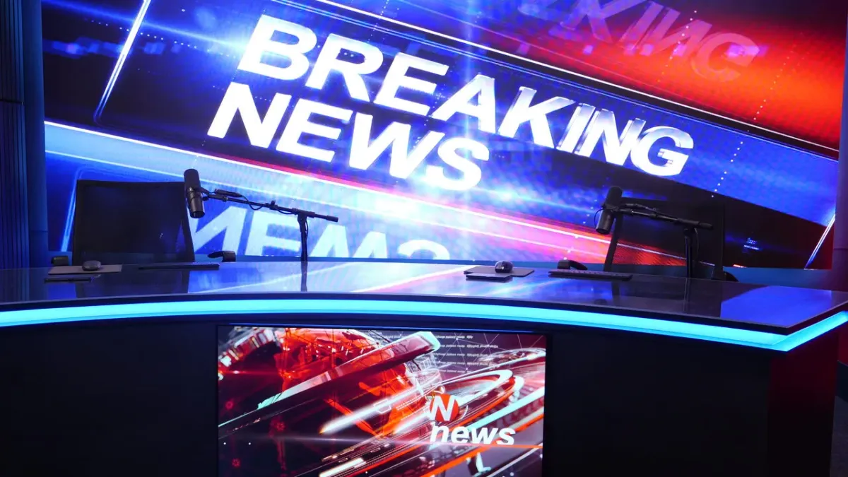 Studio 5 close-up of anchor desk microphones and 14-ft Breaking News LED wall Las Vegas